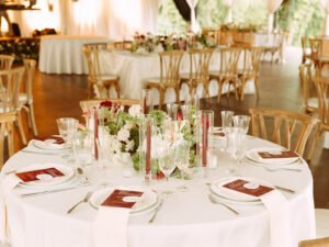 Mesas redondas con mantel blanco y flores en El Salón